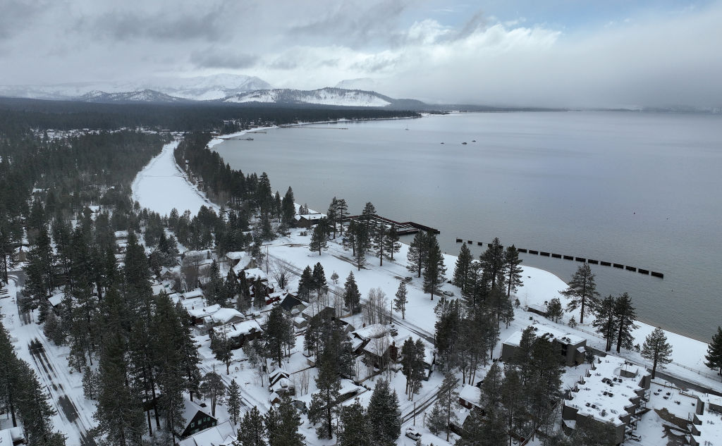 An aerial view, snow covers the banks of Lake Tahoe on March 21, 2023 in South Lake Tahoe, Californ...