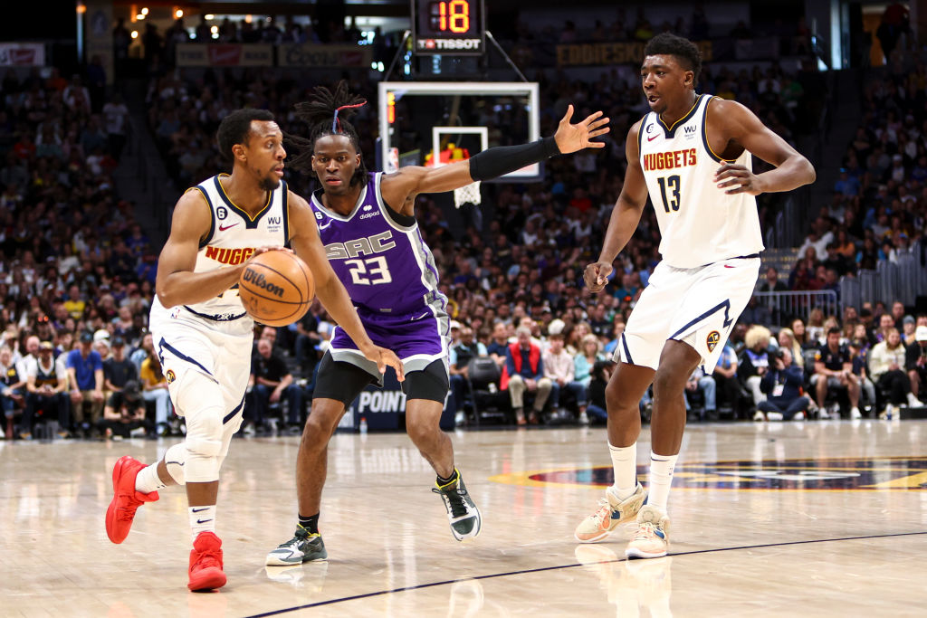 Ish Smith #14 of the Denver Nuggets moves past Keon Ellis #23 of the Sacramento Kings during the se...