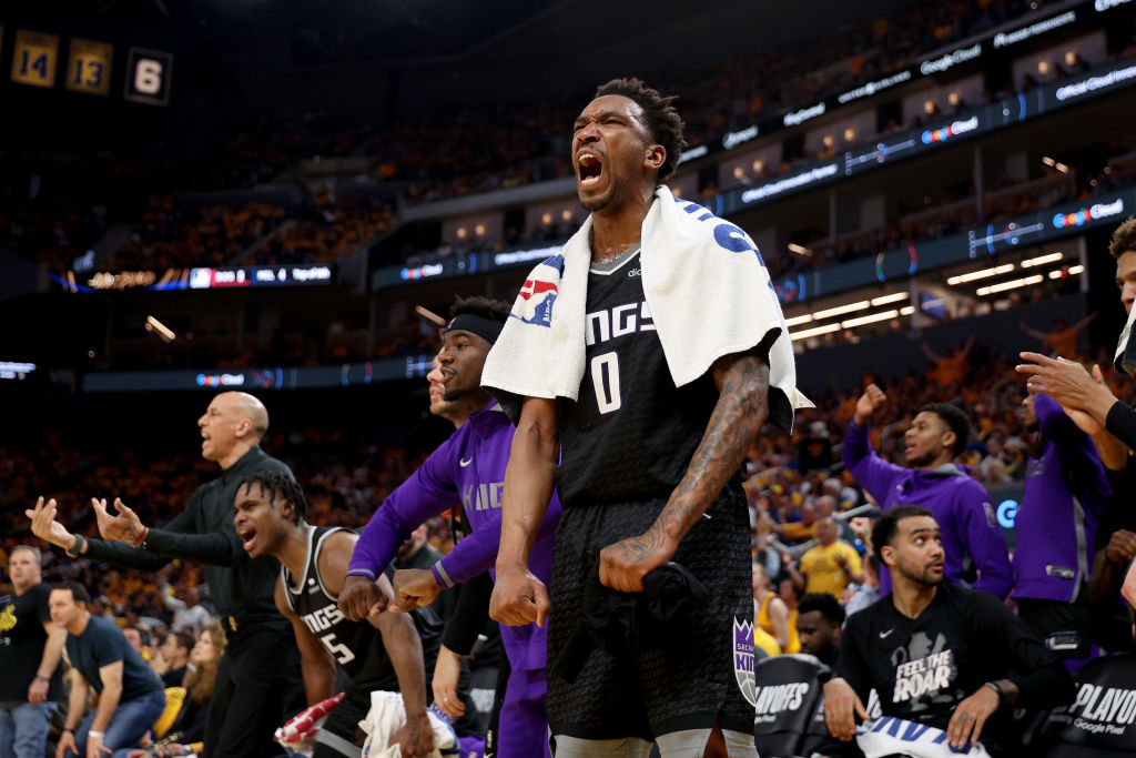 Malik Monk #0 of the Sacramento Kings cheers on his team during the first half of Game Four of the ...