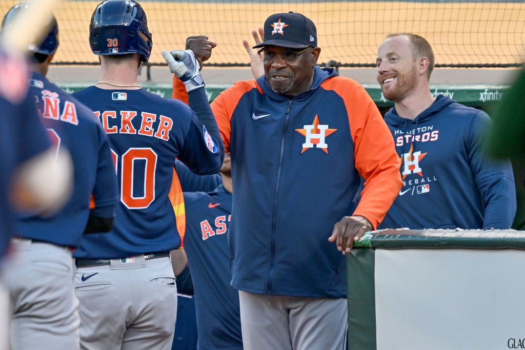 Kyle Tucker #30 of the Houston Astros celebrates with manager Dusty Baker after his home run agains...