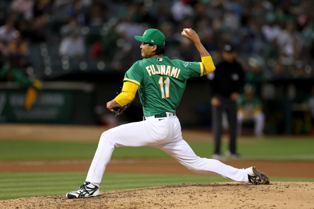 Shintaro Fujinami #11 of the Oakland Athletics pitches against the Boston Red Sox in the seventh in...
