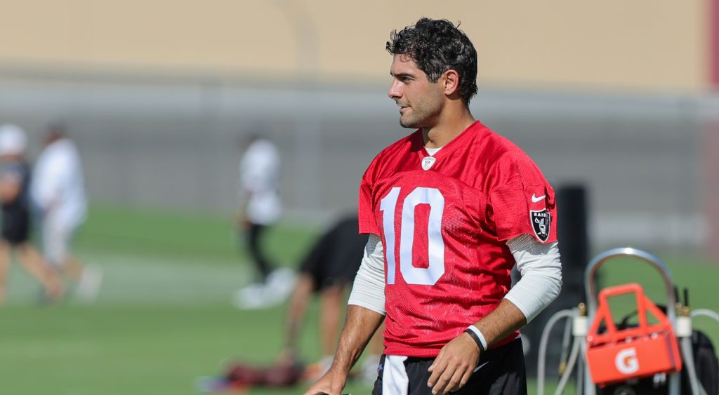 Quarterback Jimmy Garoppolo #10 of the Las Vegas Raiders runs on a field during the first practice ...