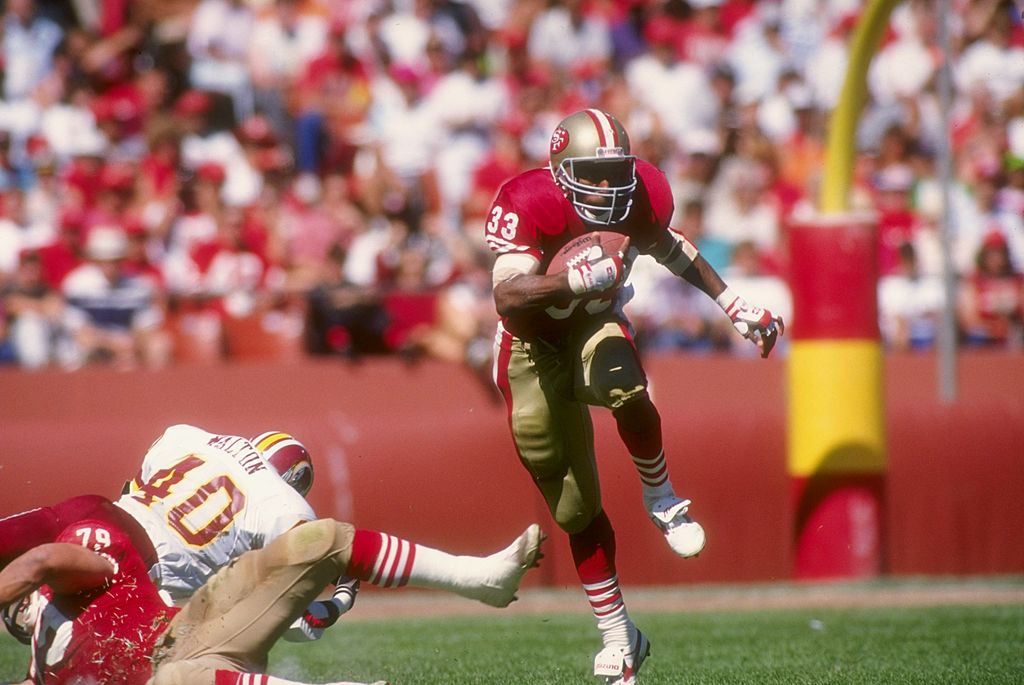 Running back Roger Craig of the San Francisco 49ers moves the ball during a game against the Washin...