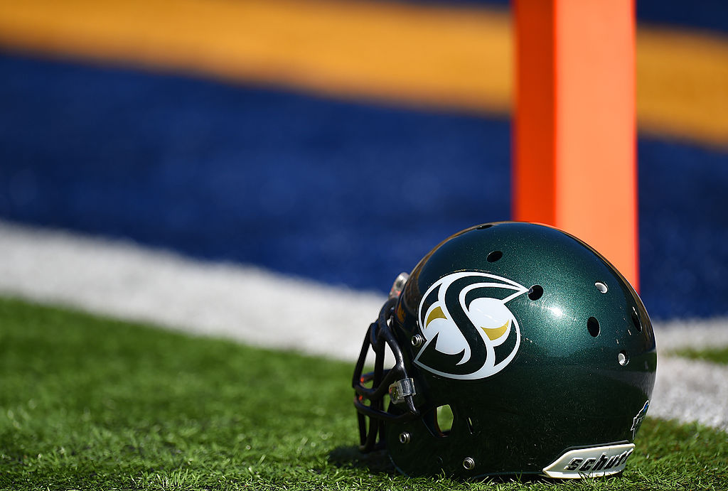 A detailed view of a helmet belonging to a Sac State Hornets football player sitting on the field p...