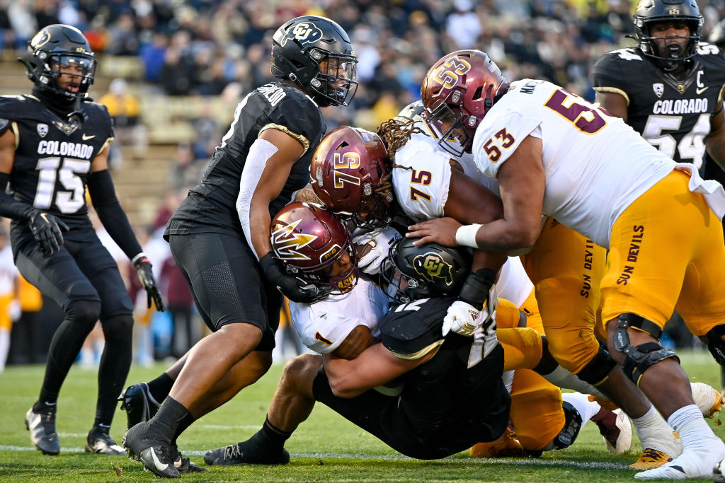 Running back Xazavian Valladay #1 of the Arizona State Sun Devils pushes accross the goal line for ...