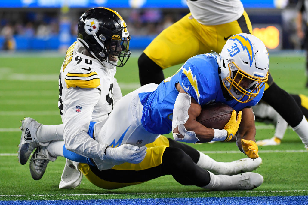 Austin Ekeler #30 of the Los Angeles Chargers dives for a touchdown as Taco Charlton #98 of the Pit...