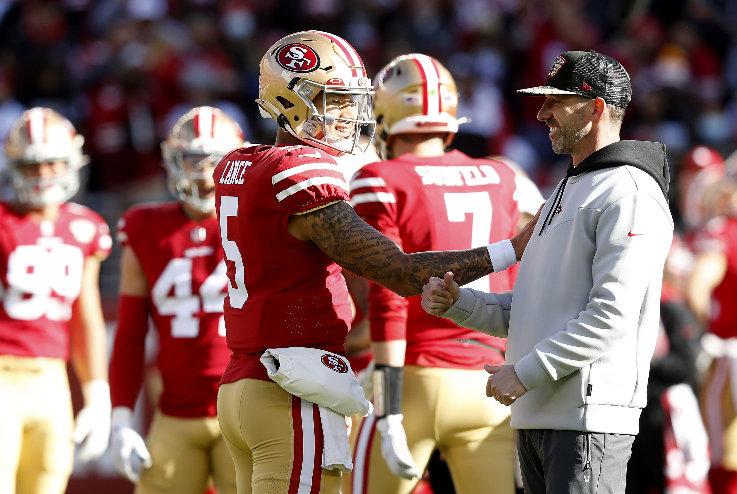 Trey Lance #5 of the San Francisco 49ers and Head Coach Kyle Shanahan of the San Francisco 49ers ta...