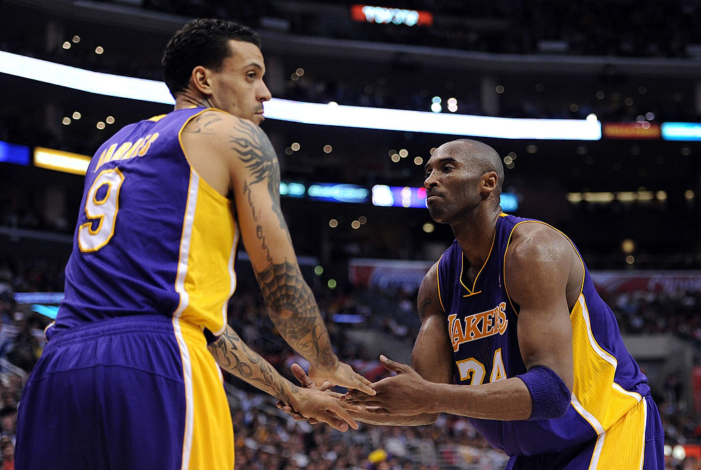 Kobe Bryant #24 and Matt Barnes #9 of the Los Angeles Lakers celebrate a defensive stop against the...