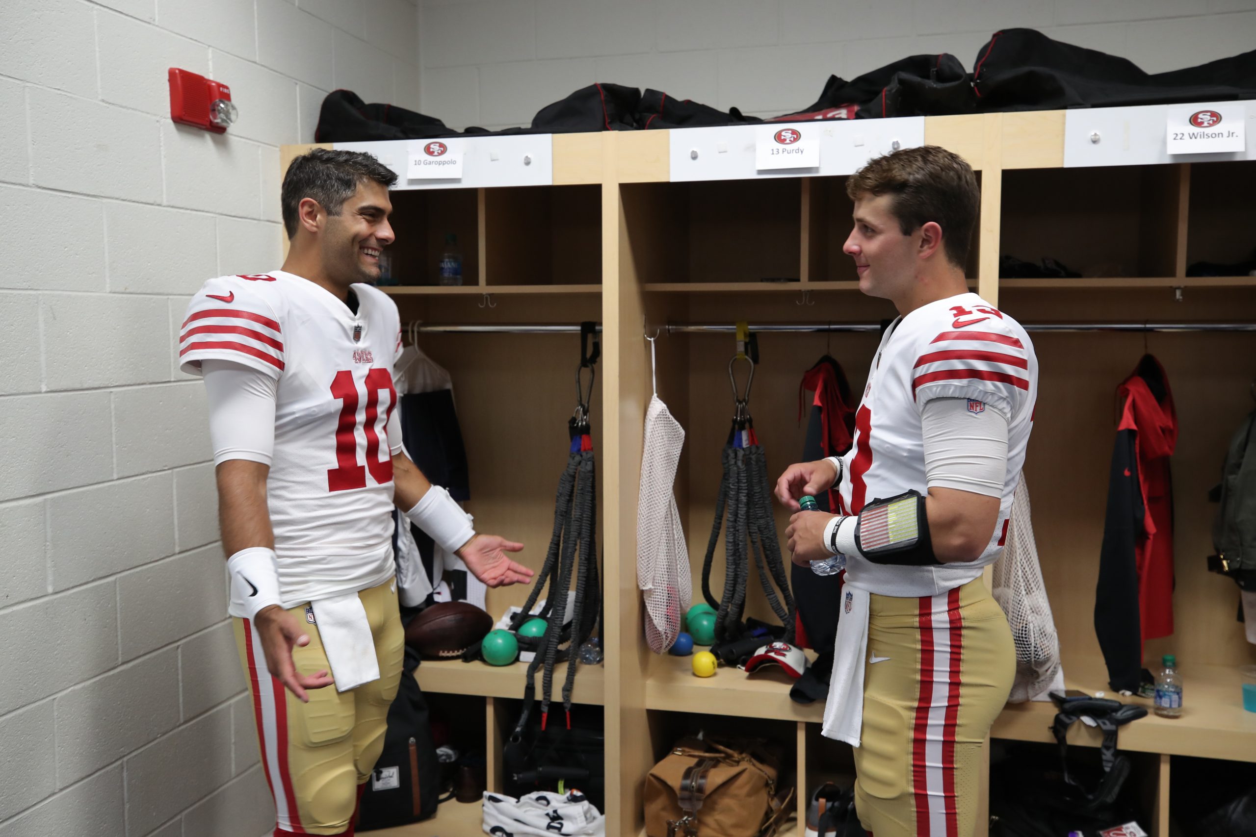 Jimmy Garoppolo #10 and Brock Purdy #13 of the San Francisco 49ers in the locker room before the ga...
