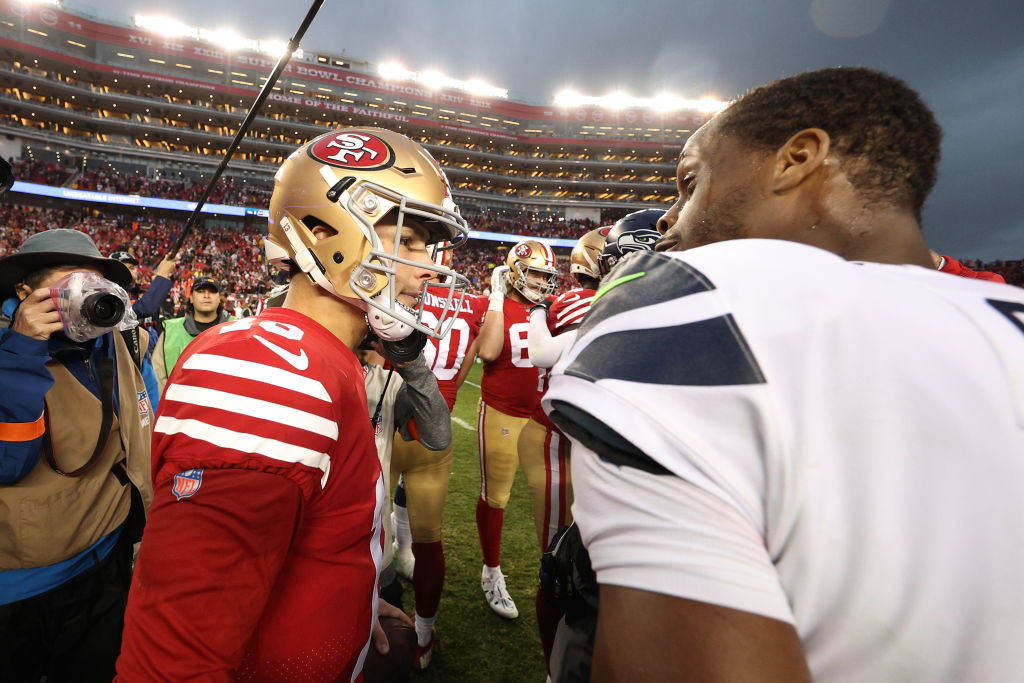 Brock Purdy #13 of the San Francisco 49ers talks with Geno Smith #7 of the Seattle Seahawks after t...