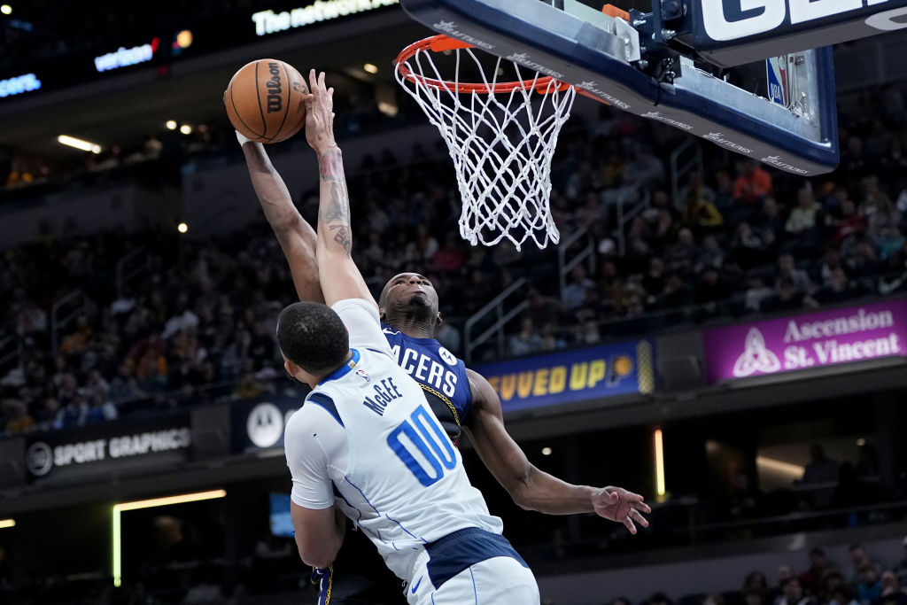 INDIANAPOLIS, INDIANA - MARCH 27: JaVale McGee #00 of the Dallas Mavericks blocks a dunk attempt by...