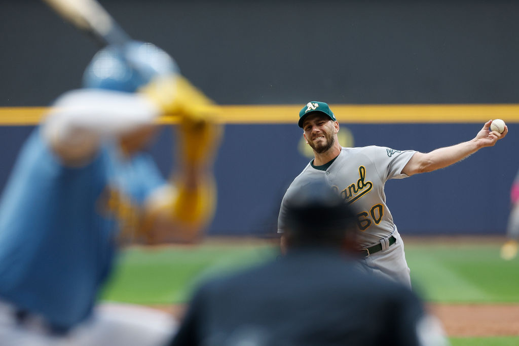 Sam Moll #60 of the Oakland Athletics throws a pitch in the first inning against the Milwaukee Brew...