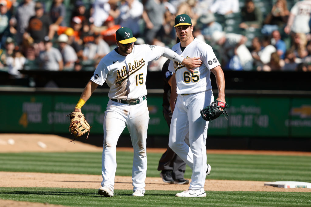 OAKLAND, CALIFORNIA - AUGUST 06: Seth Brown (L) #15 and Trevor May #65 of the Oakland Athletics cel...