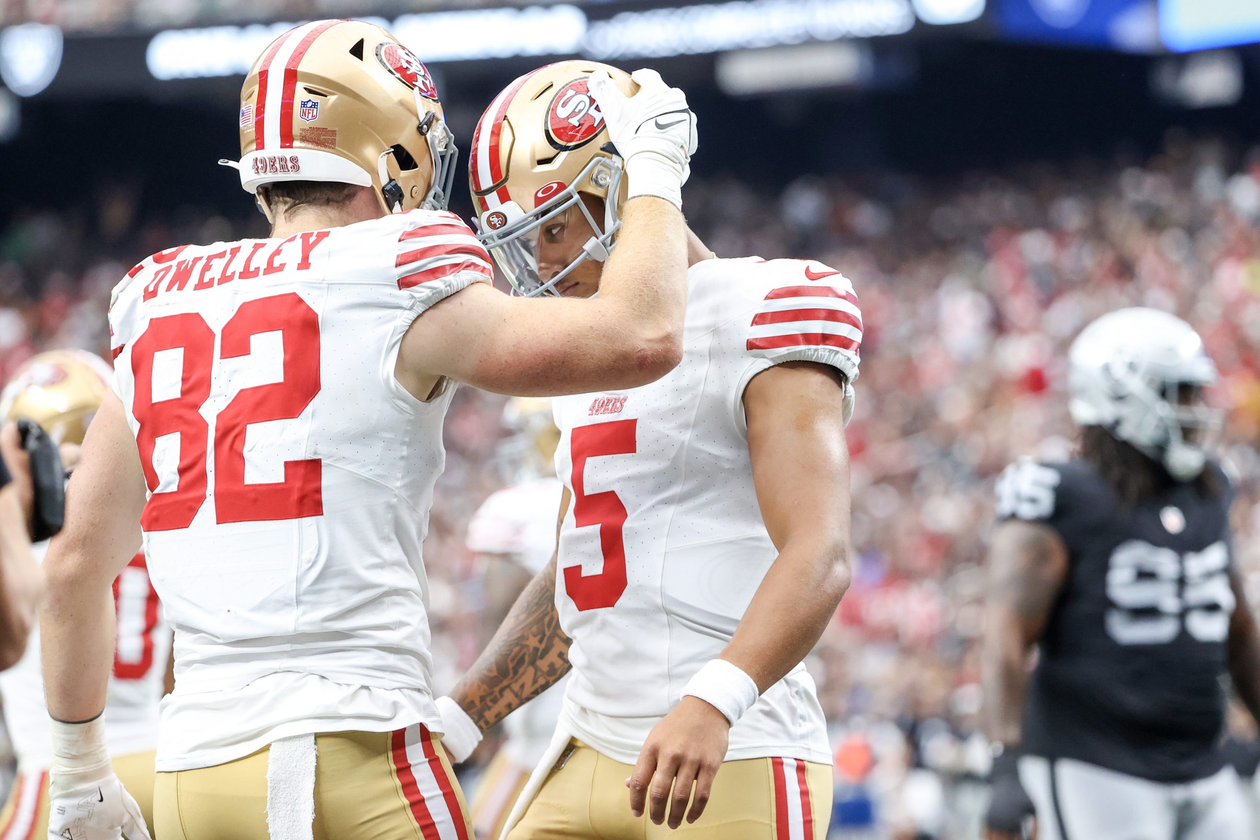 Tight end Ross Dwelley #82 of the San Francisco 49ers celebrates with quarterback Trey Lance #5 of ...
