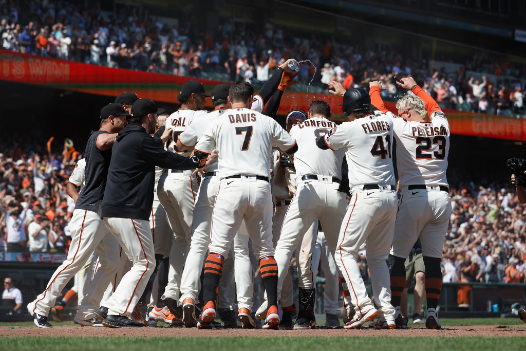 Patrick Bailey #14 of the San Francisco Giants celebrates with teammates after hitting a two-run wa...
