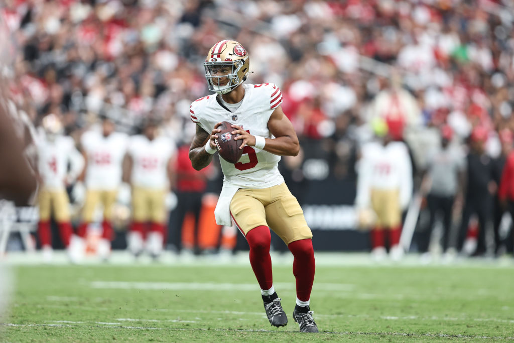 LAS VEGAS, NEVADA - AUGUST 13: Trey Lance #5 of the San Francisco 49ers scrambles and looks to pass...