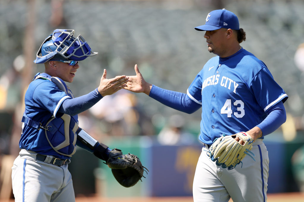 Pitcher Carlos Hernandez #43 of the Kansas City Royals is congratulated by Drew Waters #6 after the...