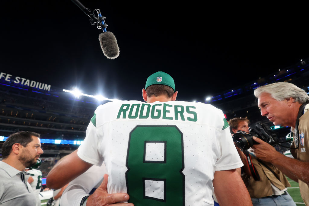 Aaron Rodgers #8 of the New York Jets greets people on the field after a preseason game New York Gi...