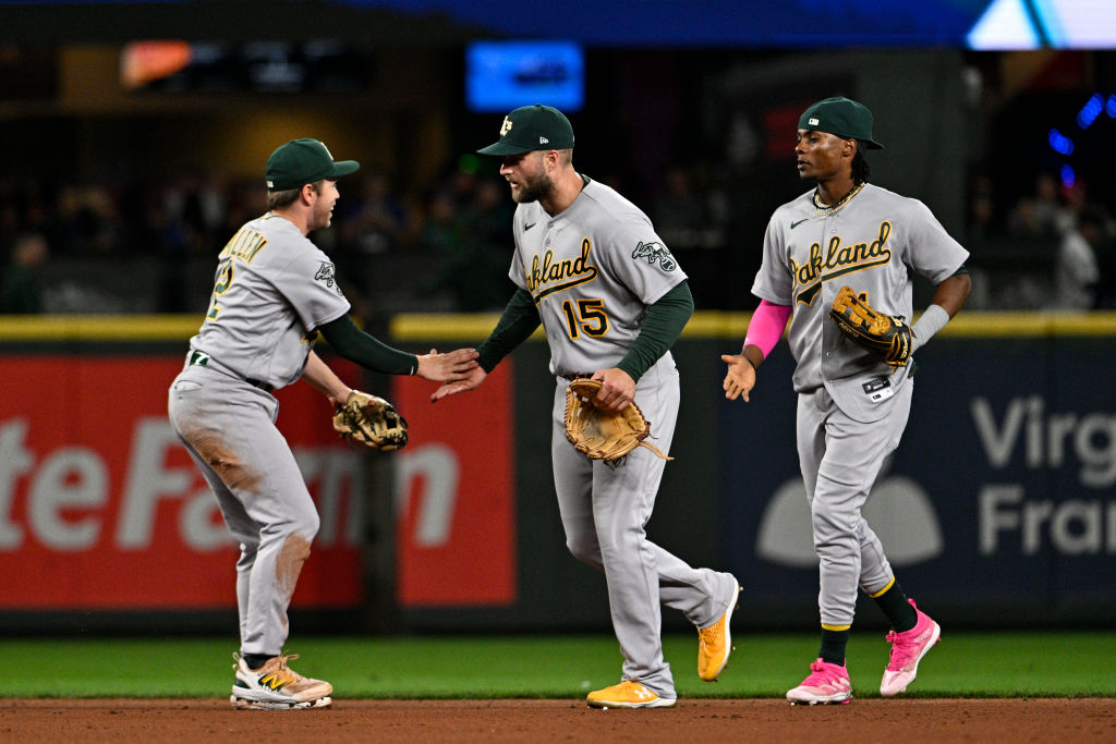 Nick Allen #2 of the Oakland Athletics, Seth Brown #15, and Lawrence Butler #22 celebrate after the...