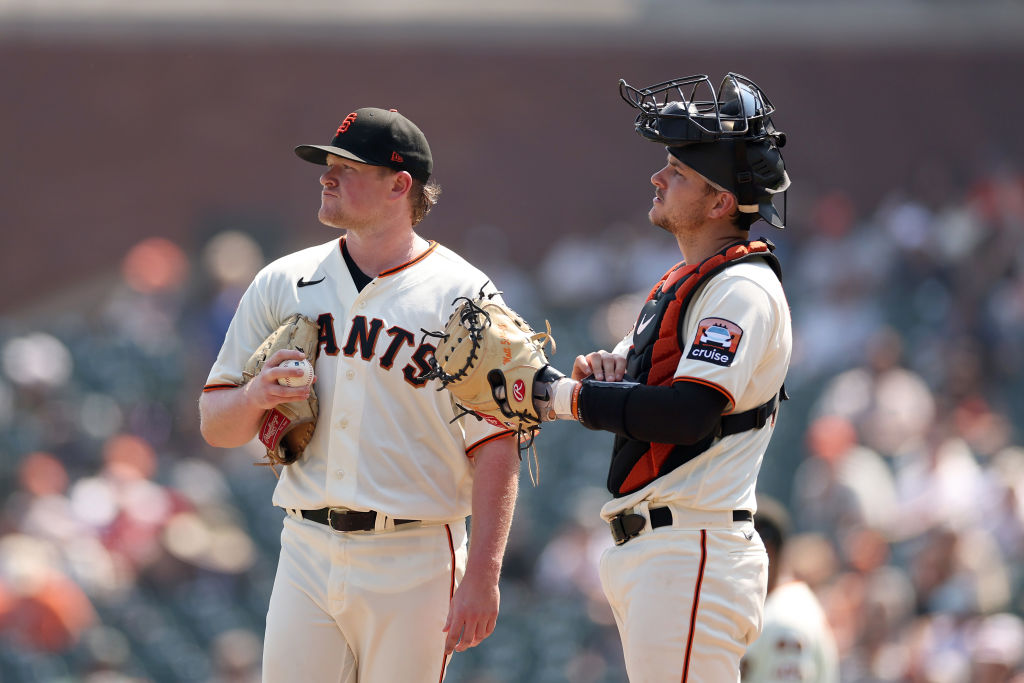 Patrick Bailey #14 comes out to speak to Logan Webb #62 of the San Francisco Giants after the Cinci...