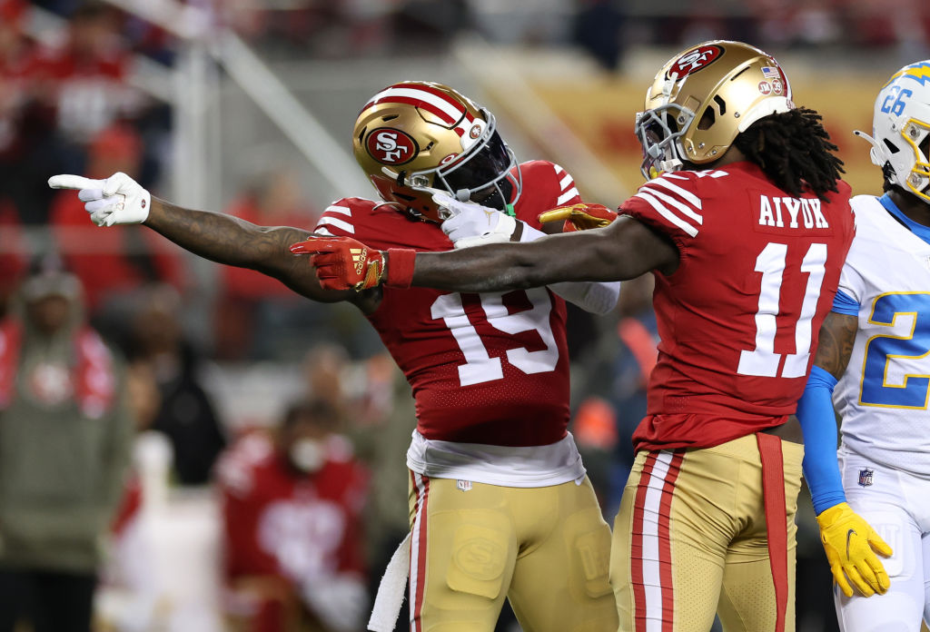 Brandon Aiyuk #11 and Deebo Samuel #19 of the San Francisco 49ers react after a first down during t...