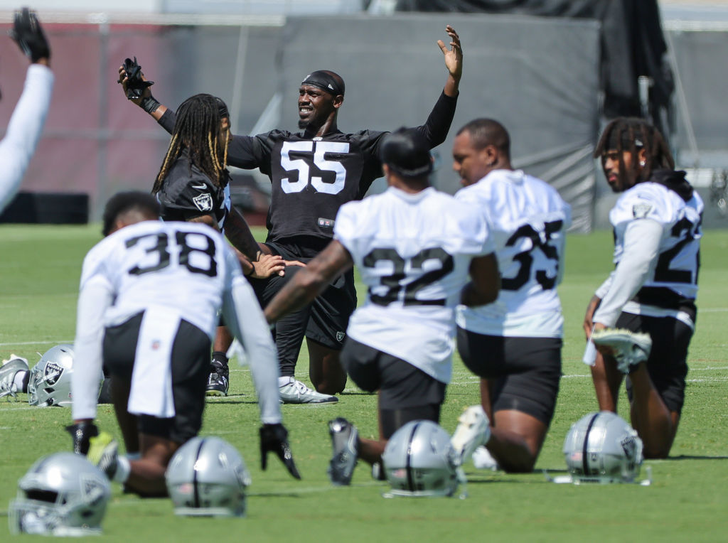 Defensive end Chandler Jones #55 of the Las Vegas Raiders warms up with teammates during mandatory ...