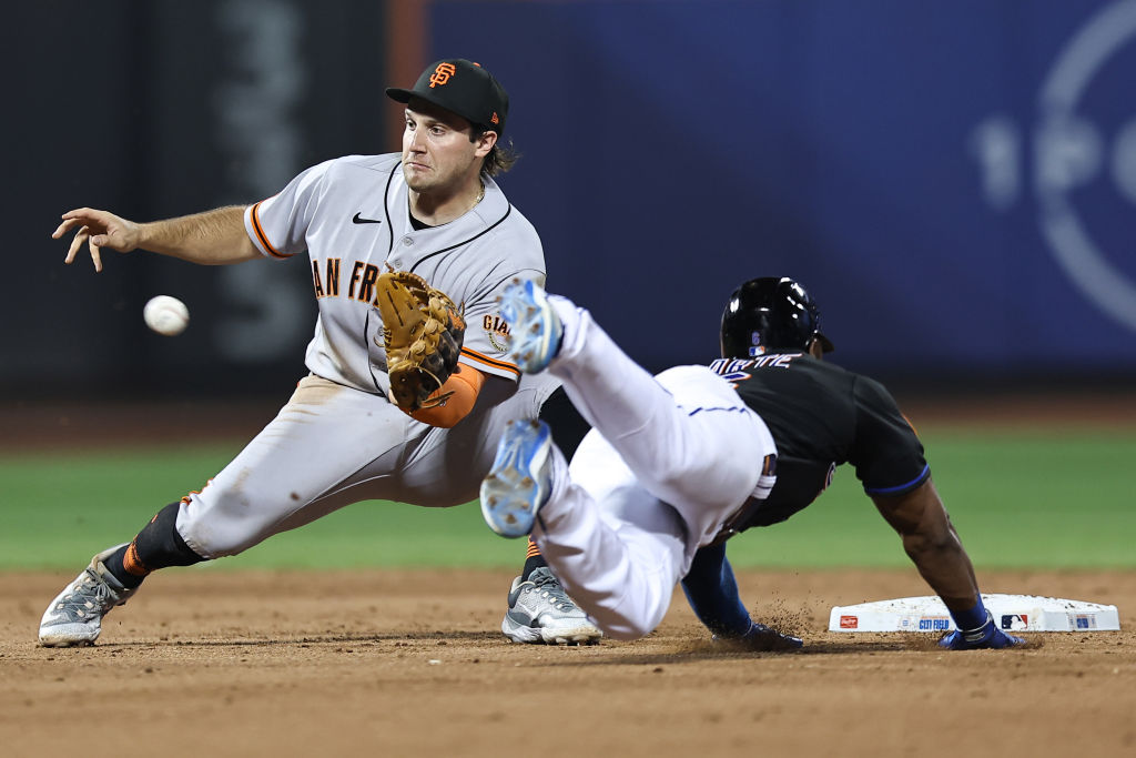 Casey Schmitt #6 of the San Francisco Giants tags Starling Marte #6 of the New York Mets out at sec...