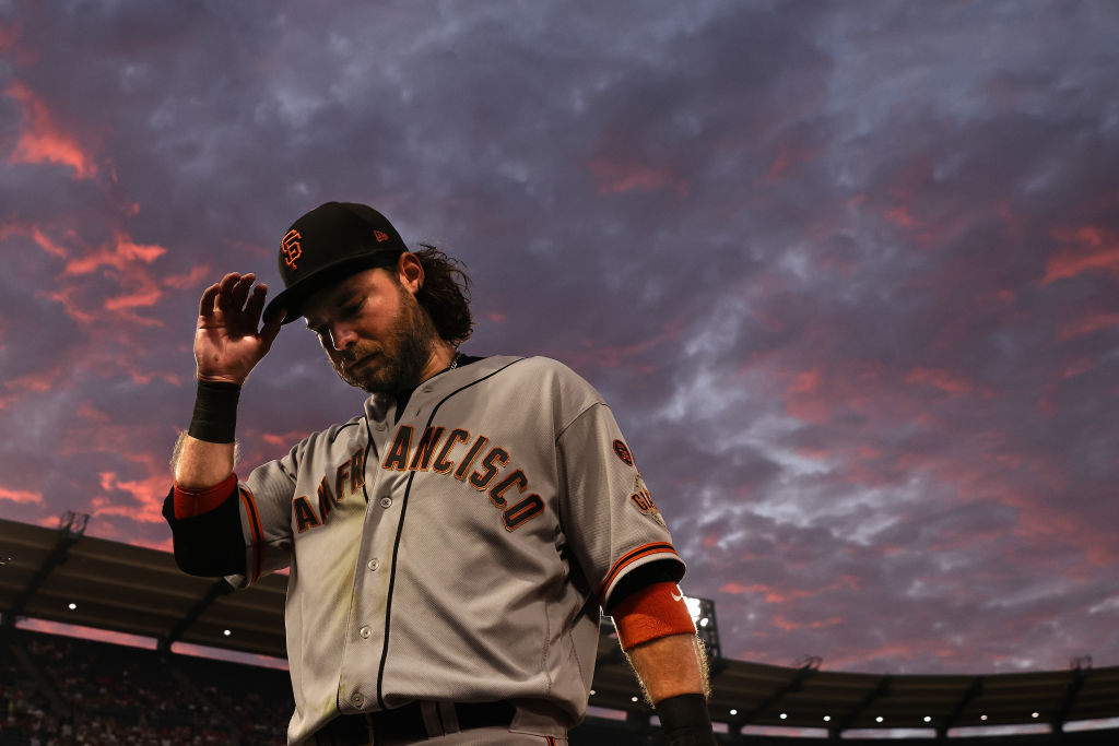 ANAHEIM, CALIFORNIA - AUGUST 08: Brandon Crawford #35 of the San Francisco Giants adjusts his hat a...