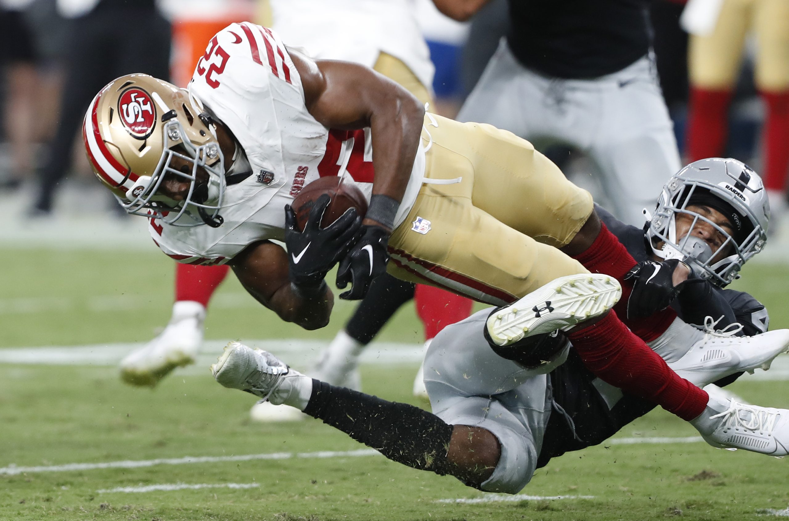 Running back Jeremy McNichols #22 of the San Francisco 49ers is tackled by cornerback Bryce Cosby #...