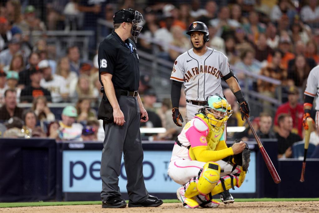 Thairo Estrada #39 of the San Francisco Giants argues with homeplate umpire umpire Lance Barrett #1...
