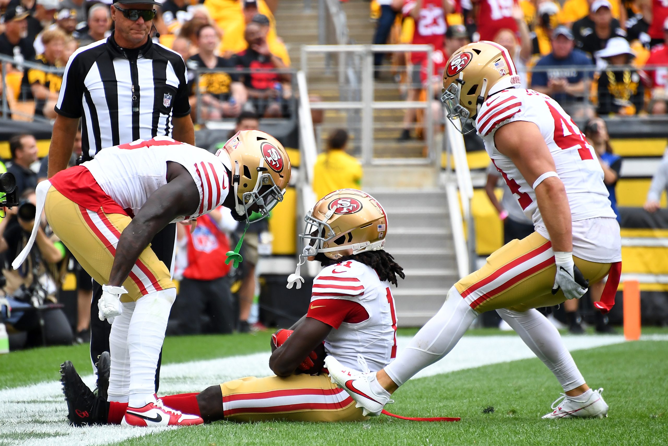 Brandon Aiyuk #11 of the San Francisco 49ers reacts with teammates after a touchdown in the first q...