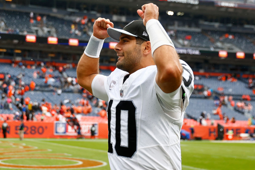 Jimmy Garoppolo #10 of the Las Vegas Raiders celebrates after his team's 17-16 win against the Denv...
