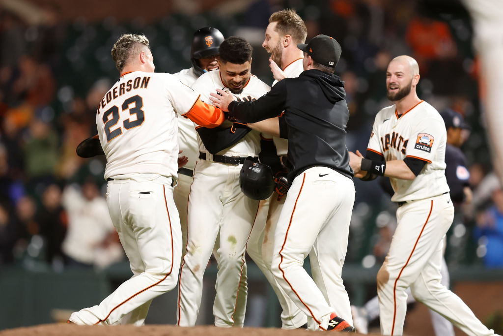 LaMonte Wade Jr. #31 of the San Francisco Giants celebrates with teammates after hitting a walk-off...