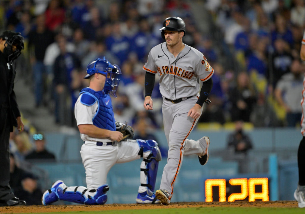 Mike Yastrzemski #5 of the San Francisco Giants comes in to score on a walk to Tyler Fitzgerald #49...