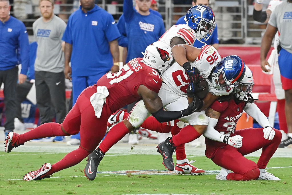 Saquon Barkley #26 of the New York Giants is tackled by Krys Barnes #51 of the Arizona Cardinals du...