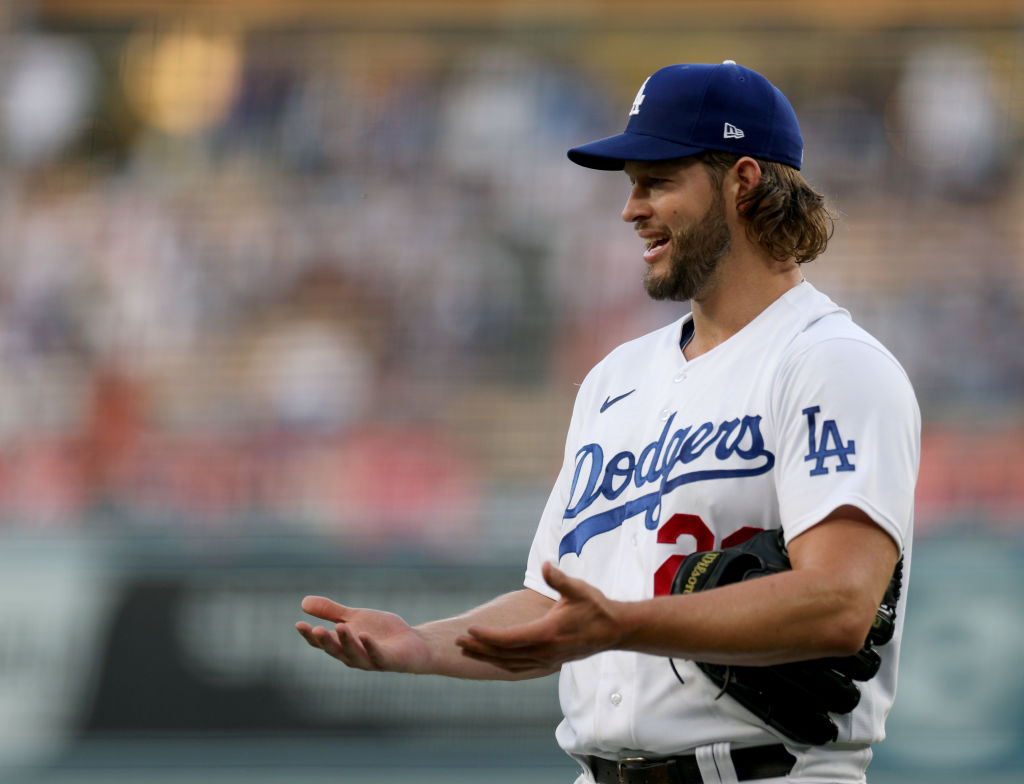 Clayton Kershaw #22 of the Los Angeles Dodgers reacts as he has his hands and gloves checked at the...