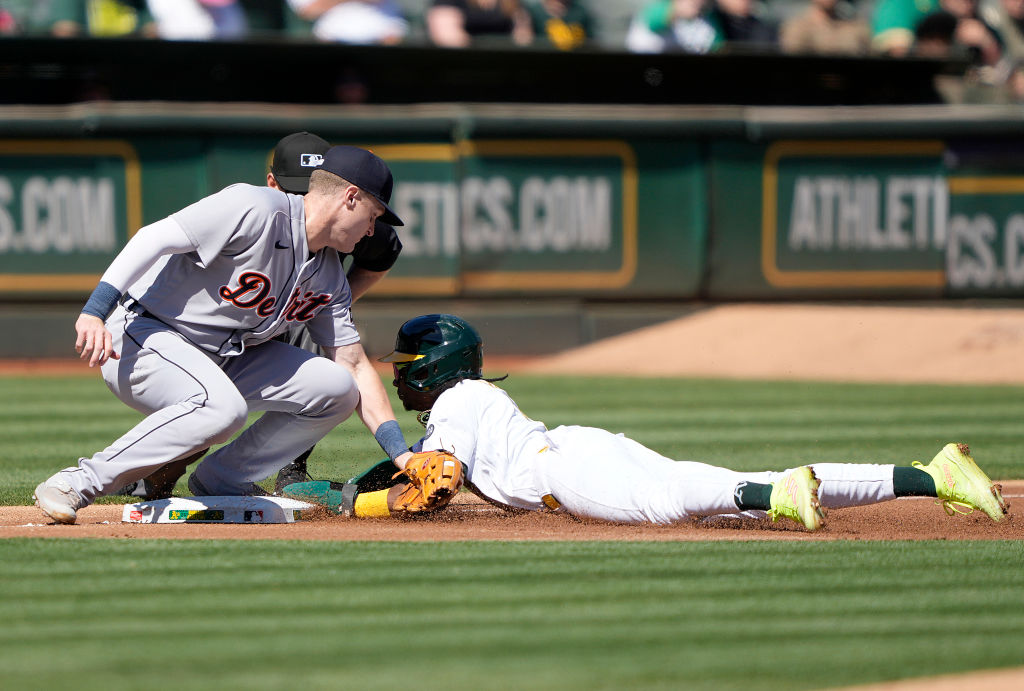 Esteury Ruiz #1 of the Oakland Athletics attempting to steal third base is tagged out by third base...
