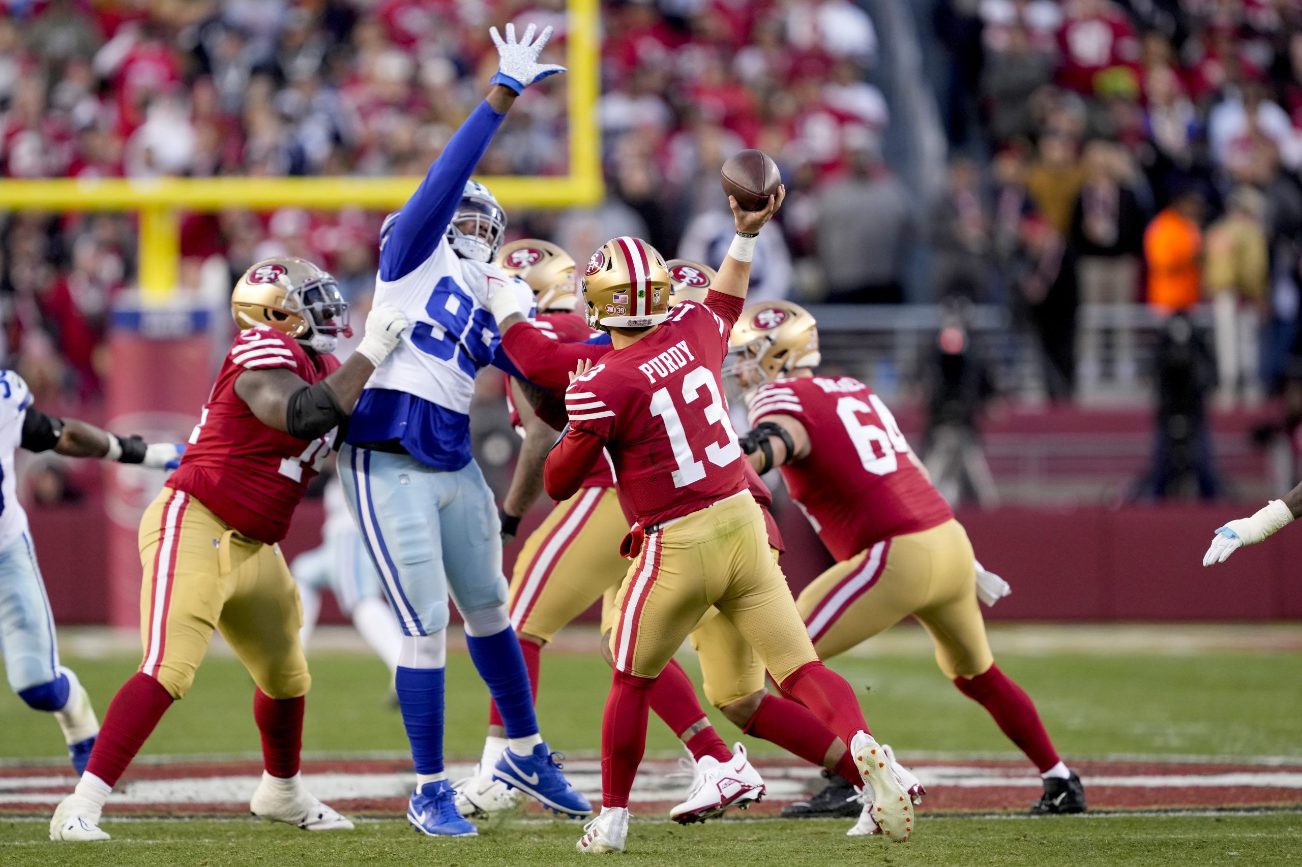 Brock Purdy #13 of the San Francisco 49ers throws a pass against the Dallas Cowboys during the seco...