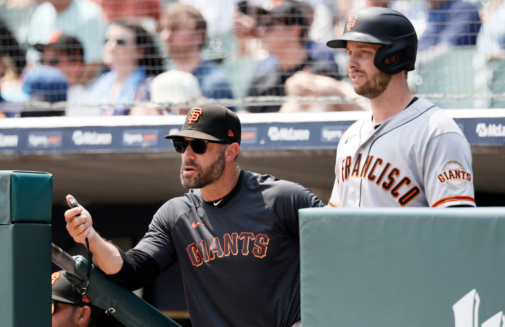 Manager Gabe Kapler #19 of the San Francisco Giants and Austin Slater #13 watch from the dugout dur...
