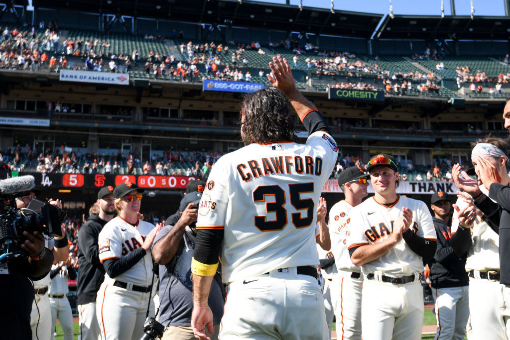 Brandon Crawford #35 of the San Francisco Giants waves to his fans after his final baseball game ag...