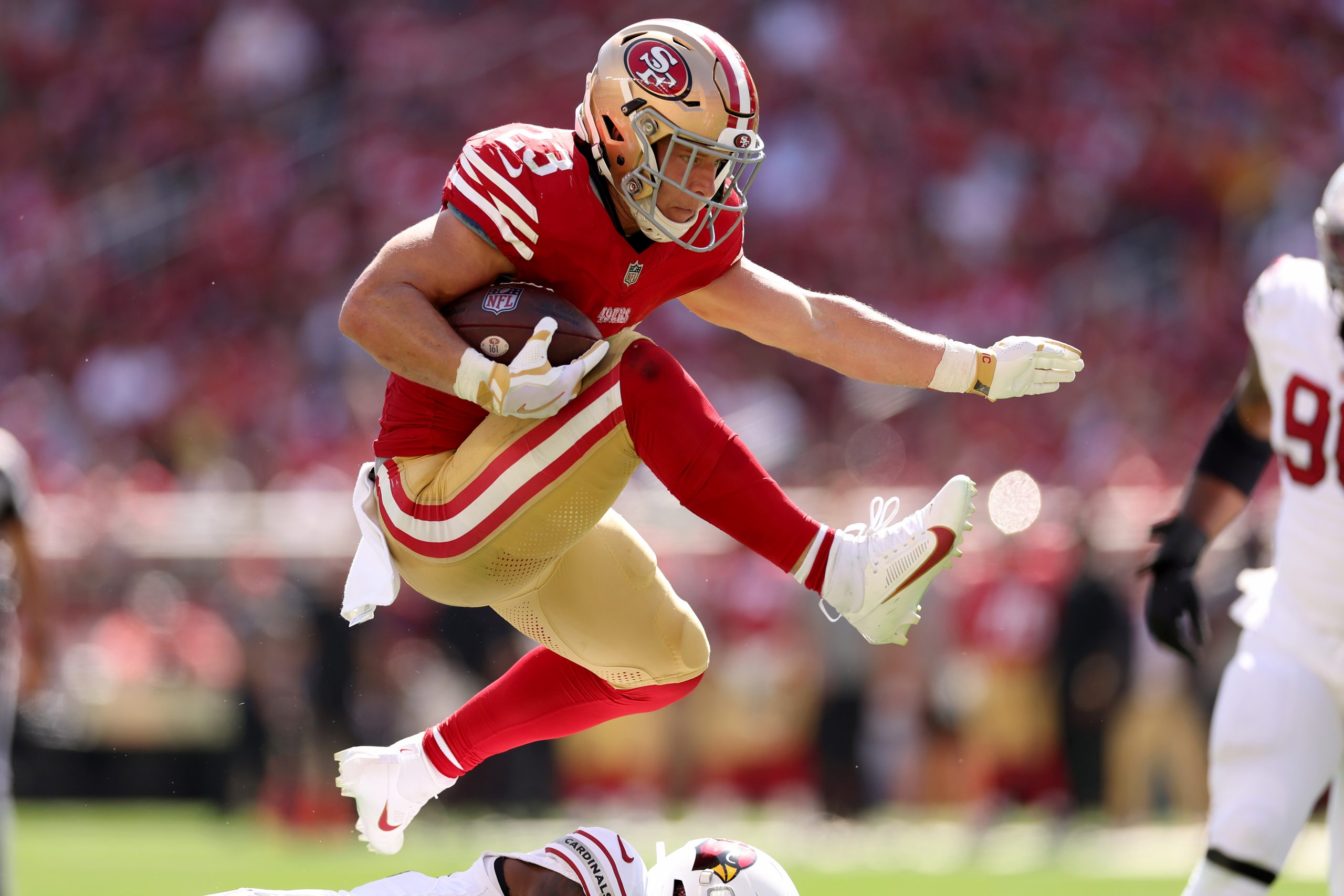 Christian McCaffrey #23 of the San Francisco 49ers runs with the ball against the Arizona Cardinals...