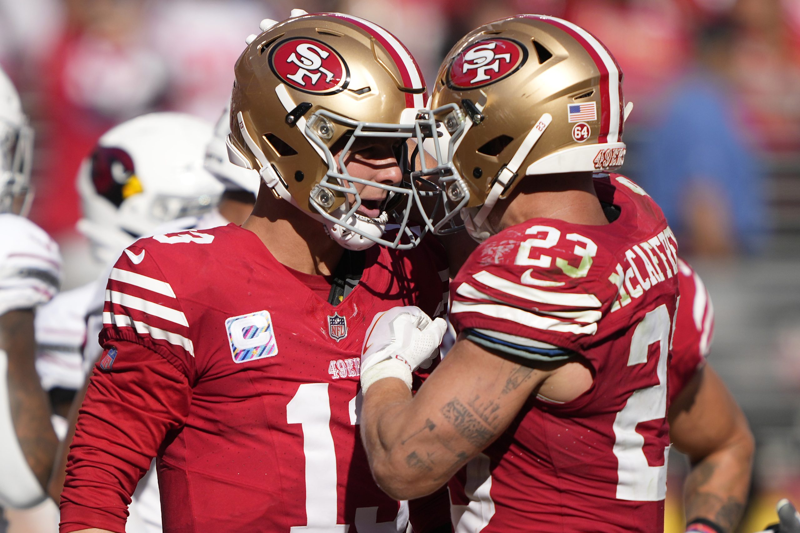 Brock Purdy #13 of the San Francisco 49ers celebrates his rushing touchdown with Christian McCaffre...