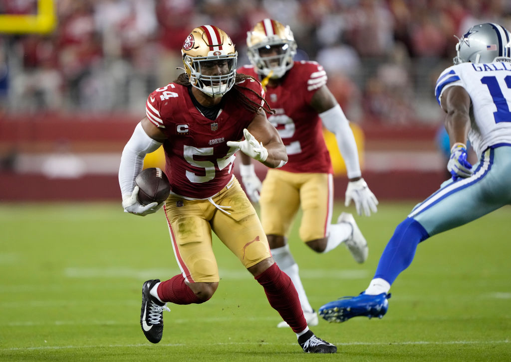 Fred Warner #54 of the San Francisco 49ers runs with the ball after intercepting a pass from Dak Pr...