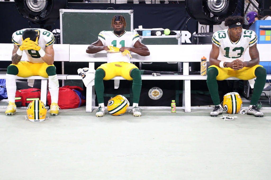 Christian Watson #9, Jayden Reed #11, and Dontayvion Wicks #13 of the Green Bay Packers react after...