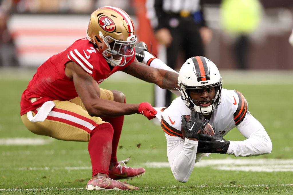 David Bell #18 of the Cleveland Browns dives for a first down past Charvarius Ward #7 of the San Fr...