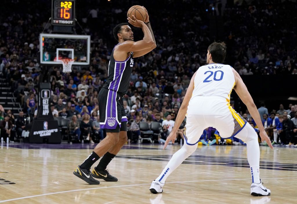 Trey Lyles #41 of the Sacramento Kings shoots over Dario Saric #20 of the Golden State Warriors dur...