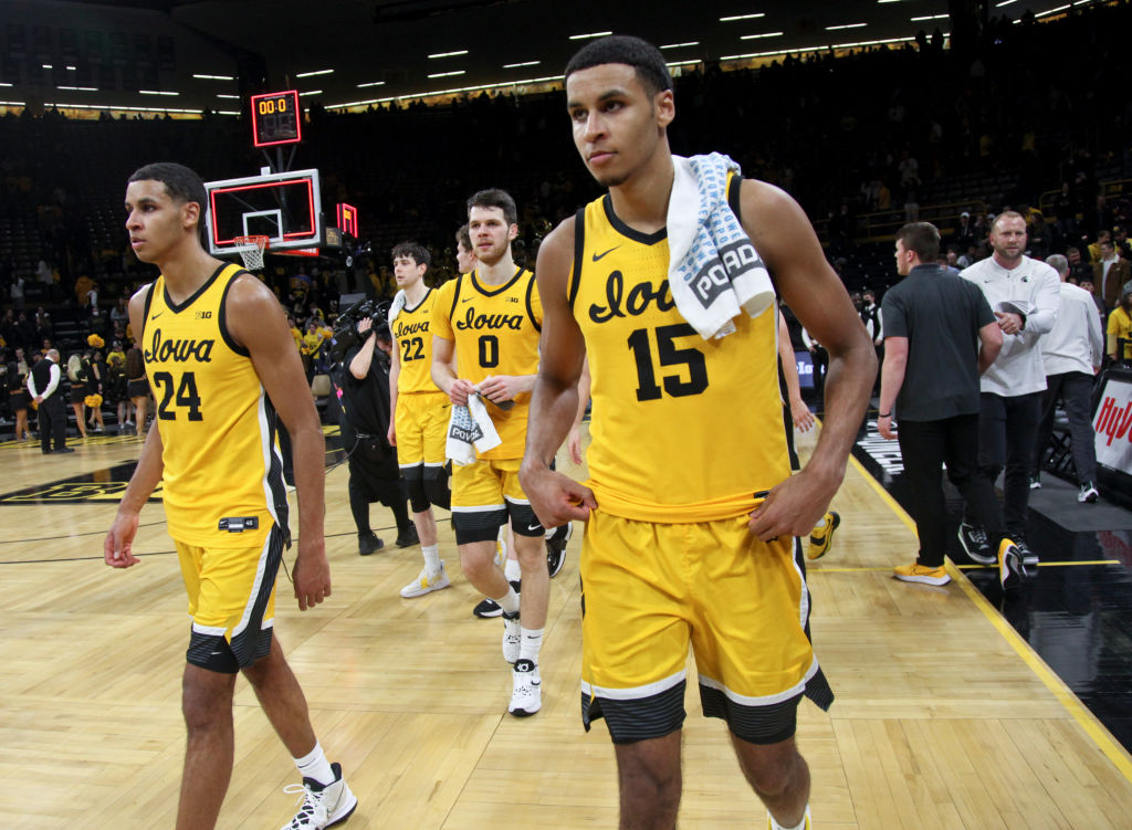 Forwards Keegan Murray #15 and Kris Murray #24 of the Iowa Hawkeyes walk off the court following th...