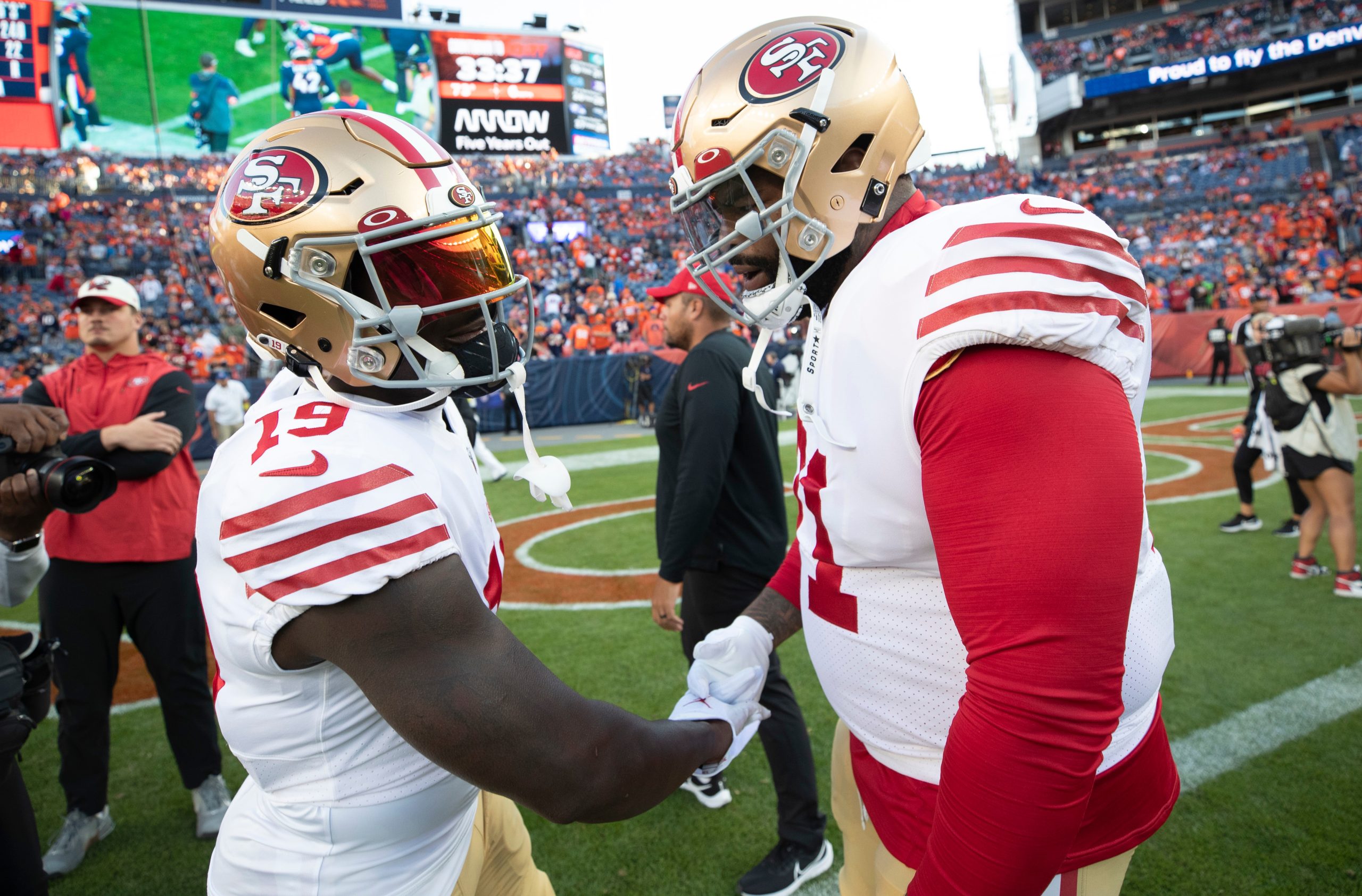 Deebo Samuel #19 and Trent Williams #71 of the San Francisco 49ers on the field before the game aga...