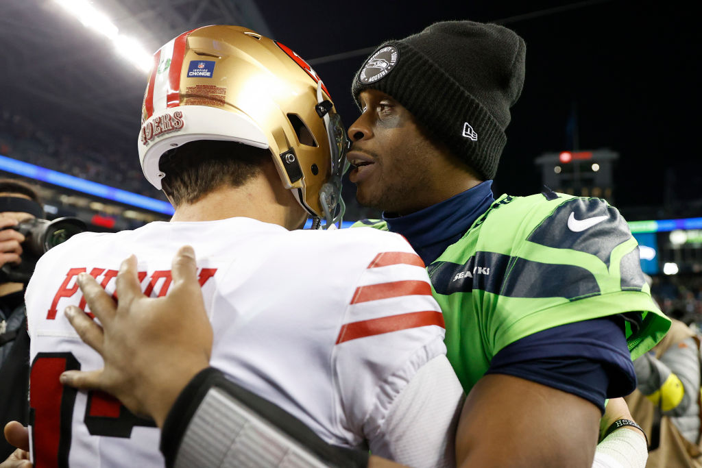 Brock Purdy #13 of the San Francisco 49ers and Geno Smith #7 of the Seattle Seahawks meet on the fi...