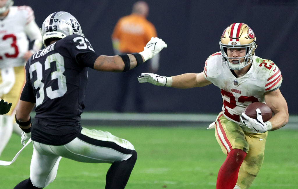 Running back Christian McCaffrey #23 of the San Francisco 49ers carries the ball against safety Rod...